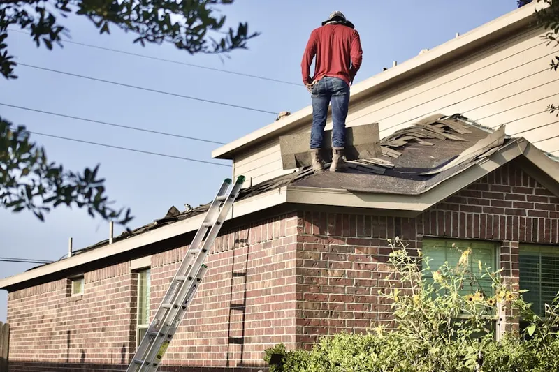 Professional roofer working on a residential roof in Huffnagle